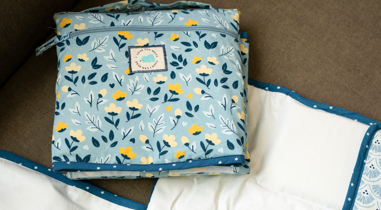blue travel changing mat with floral prints on it