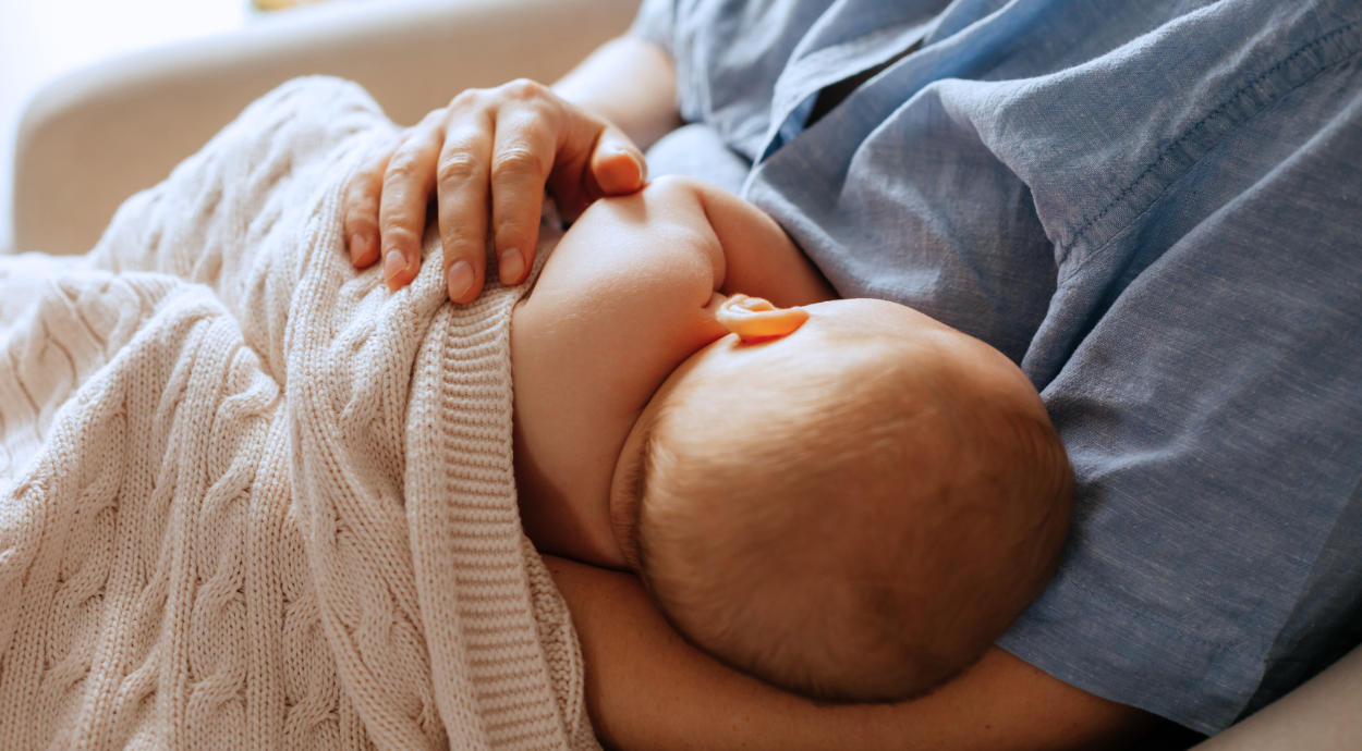 A mother breastfeeding her newborn baby