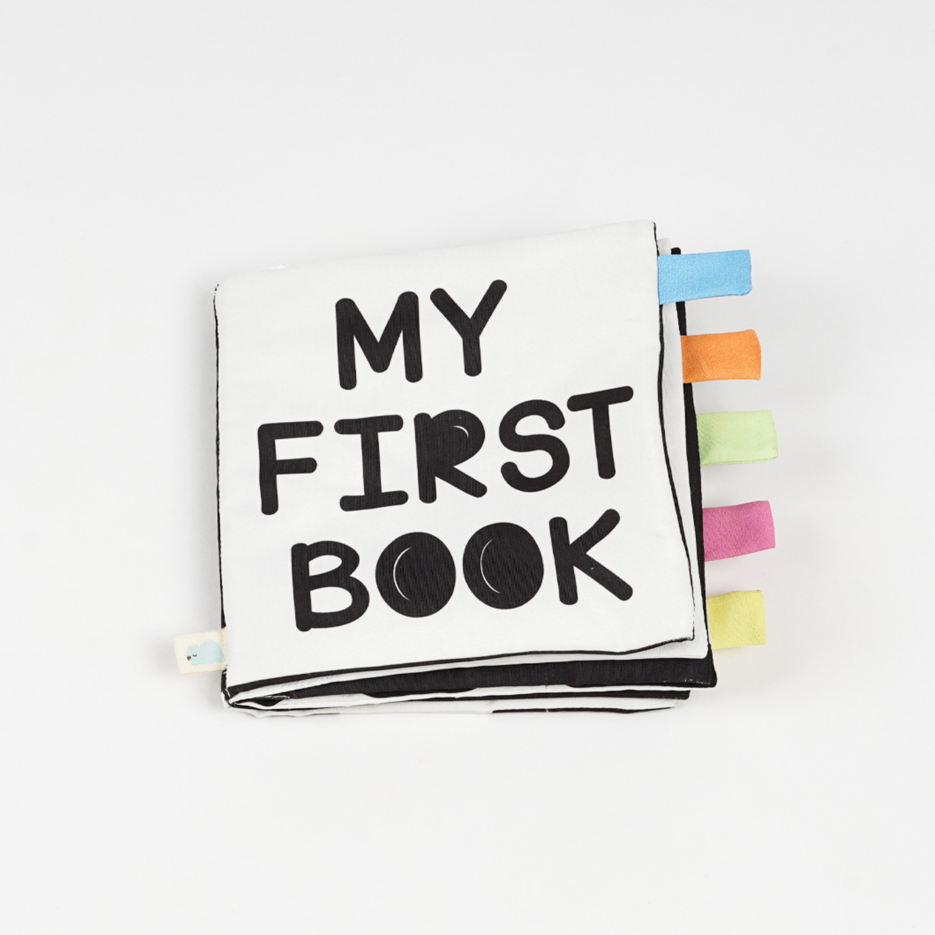 A colorful fabric baby book titled "My First Book" with various textured tags on the side, ideal for early childhood reading.