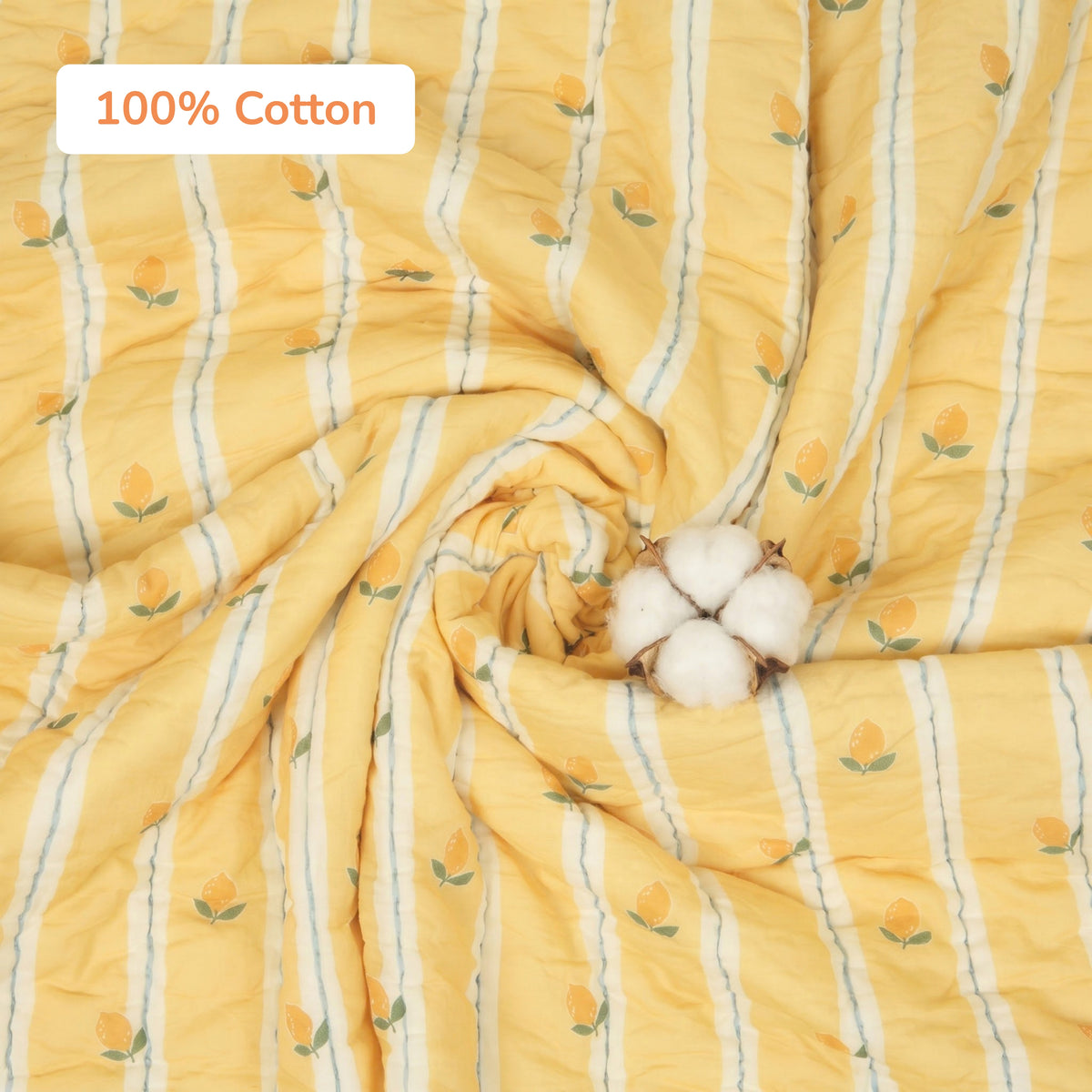 Yellow 100% cotton fabric with vertical white stripes and small yellow floral motifs, shown draped in a spiral with a cotton boll prop and a '100% Cotton' label overlay.