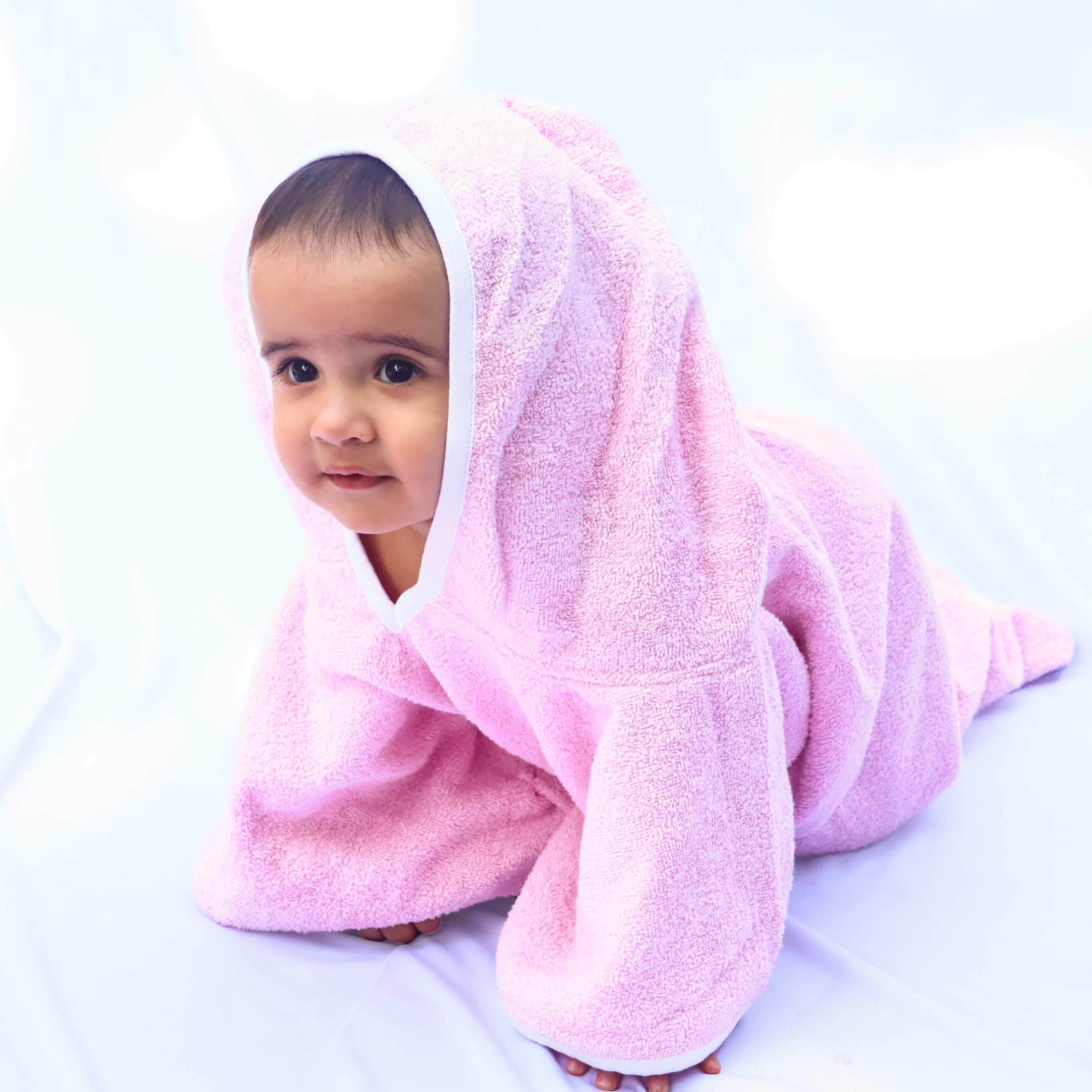 baby wrapped in a pink bath towel