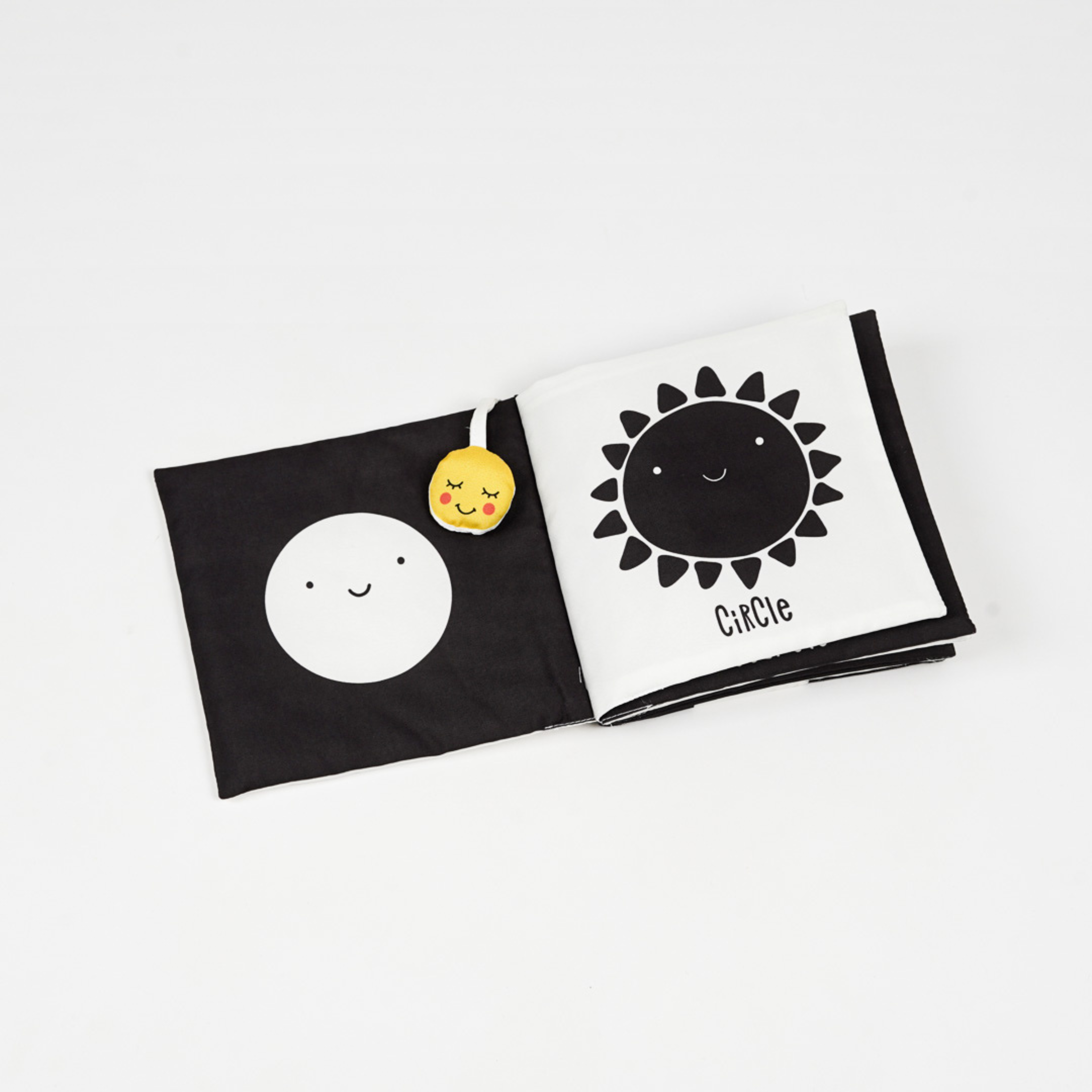 A colorful cloth book featuring smiling sun and circle shapes, designed for early childhood learning and play.