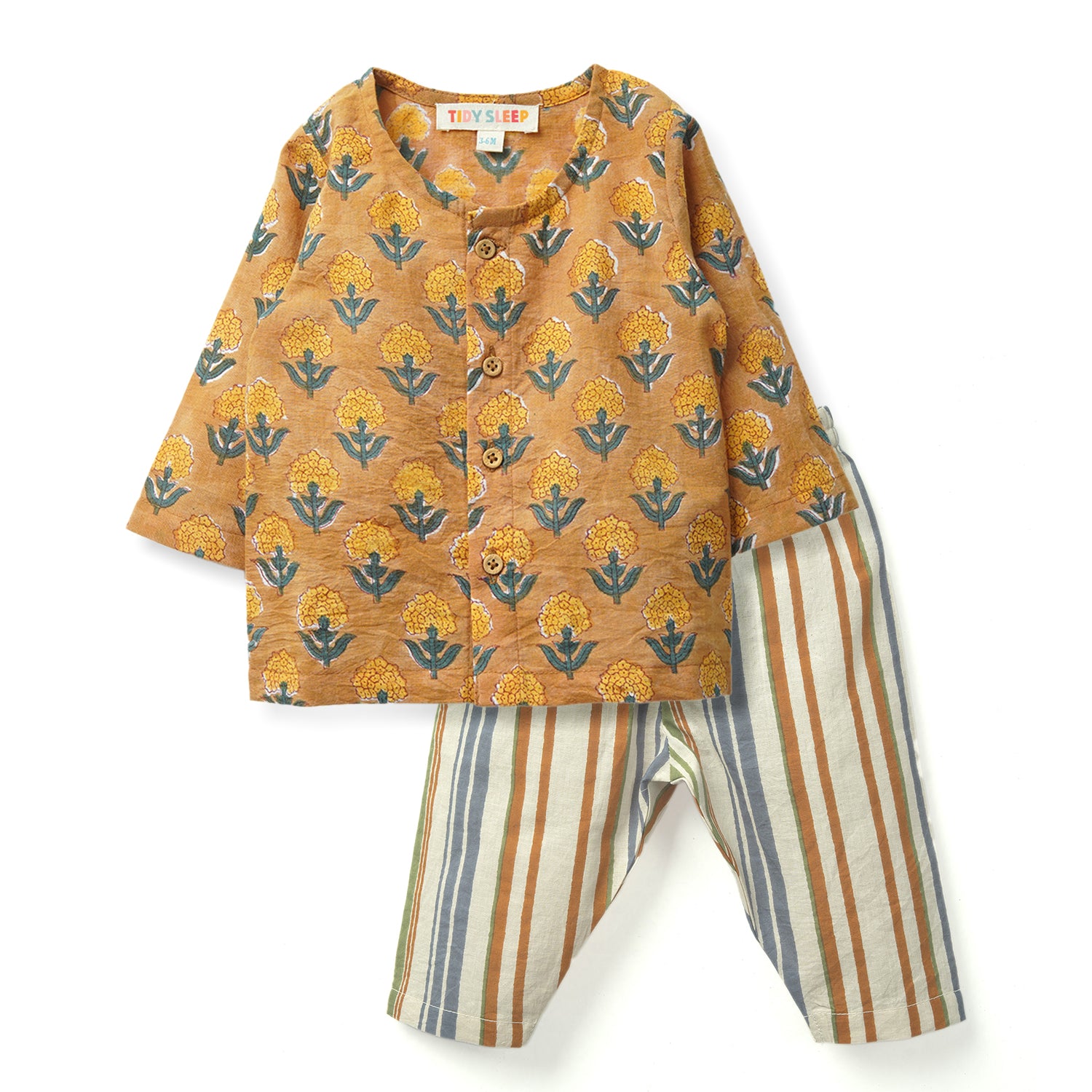A cozy baby's outfit featuring a floral patterned block printed jhabla set and striped cream pants, perfect for sleepwear or lounging.