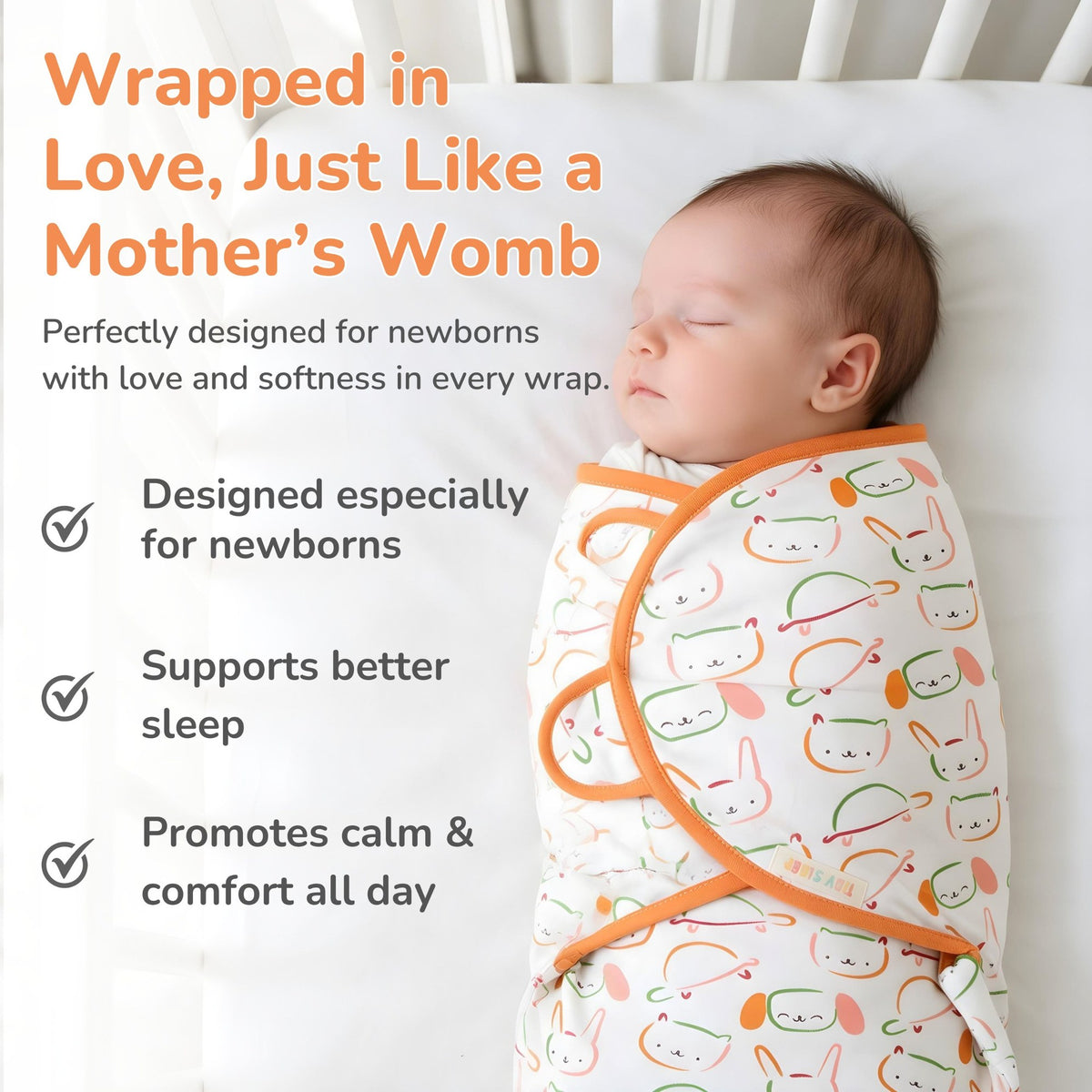 A sleeping newborn baby swaddled in a white hug me cotton jersey swaddle with orange trim and a playful pattern of cartoon faces, set against a white crib background with promotional text on the left.