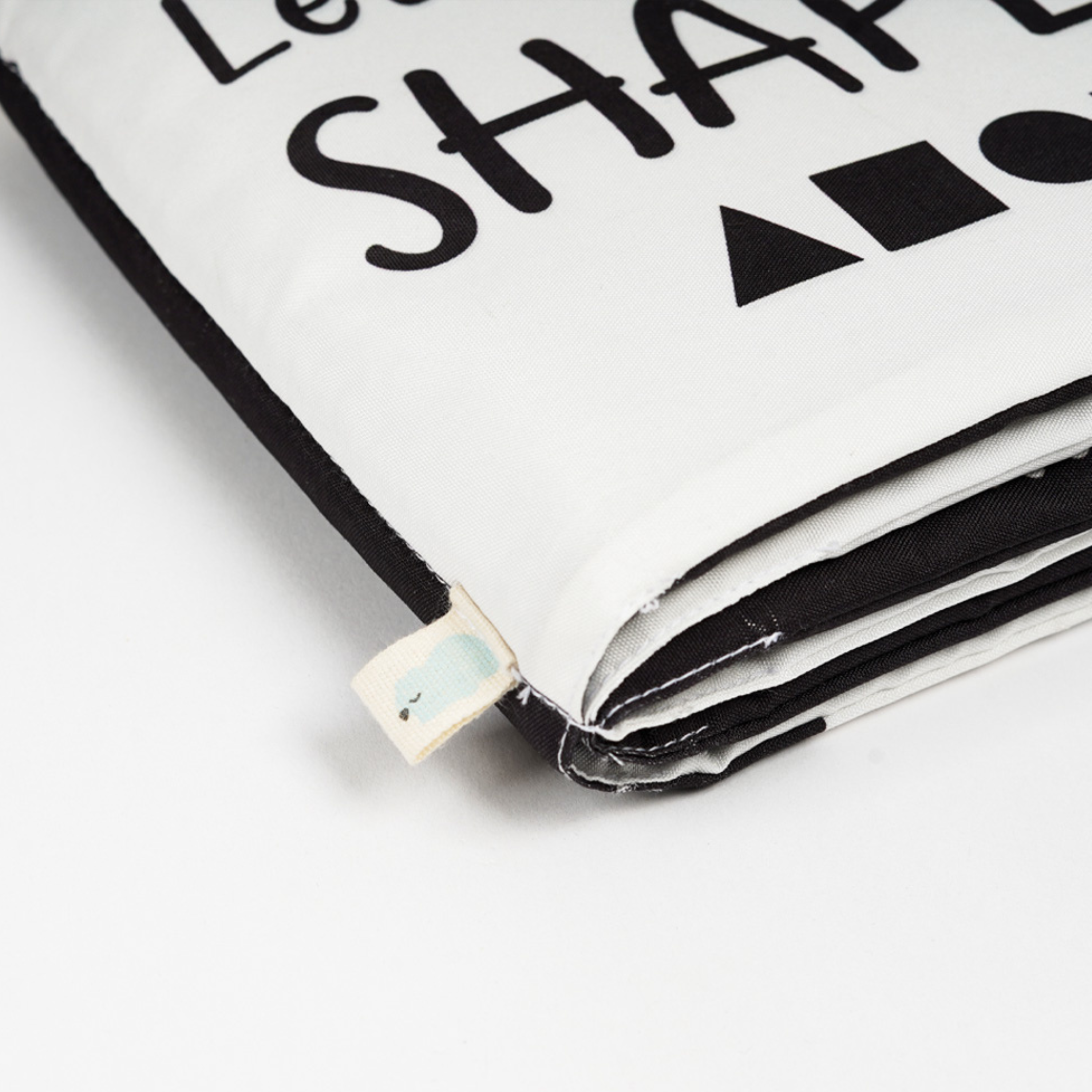 Closeup view of a white color cloth made high contrast book for baby