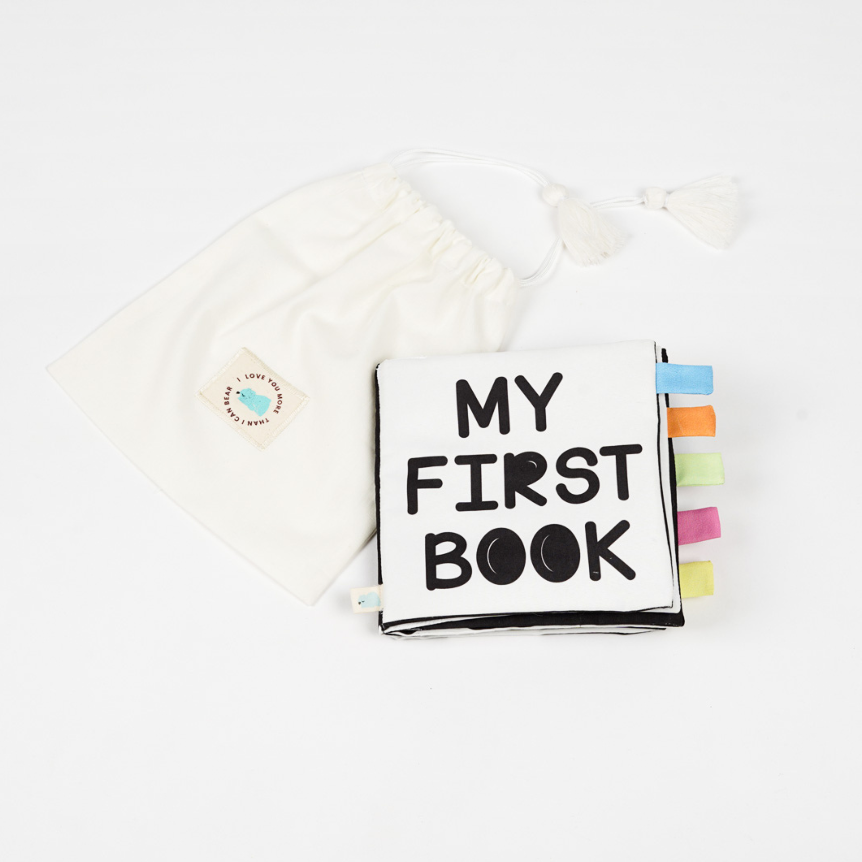 A soft fabric high contrast book for baby titled "My First Book" with colorful tabs, accompanied by a drawstring storage bag. Ideal for infants.