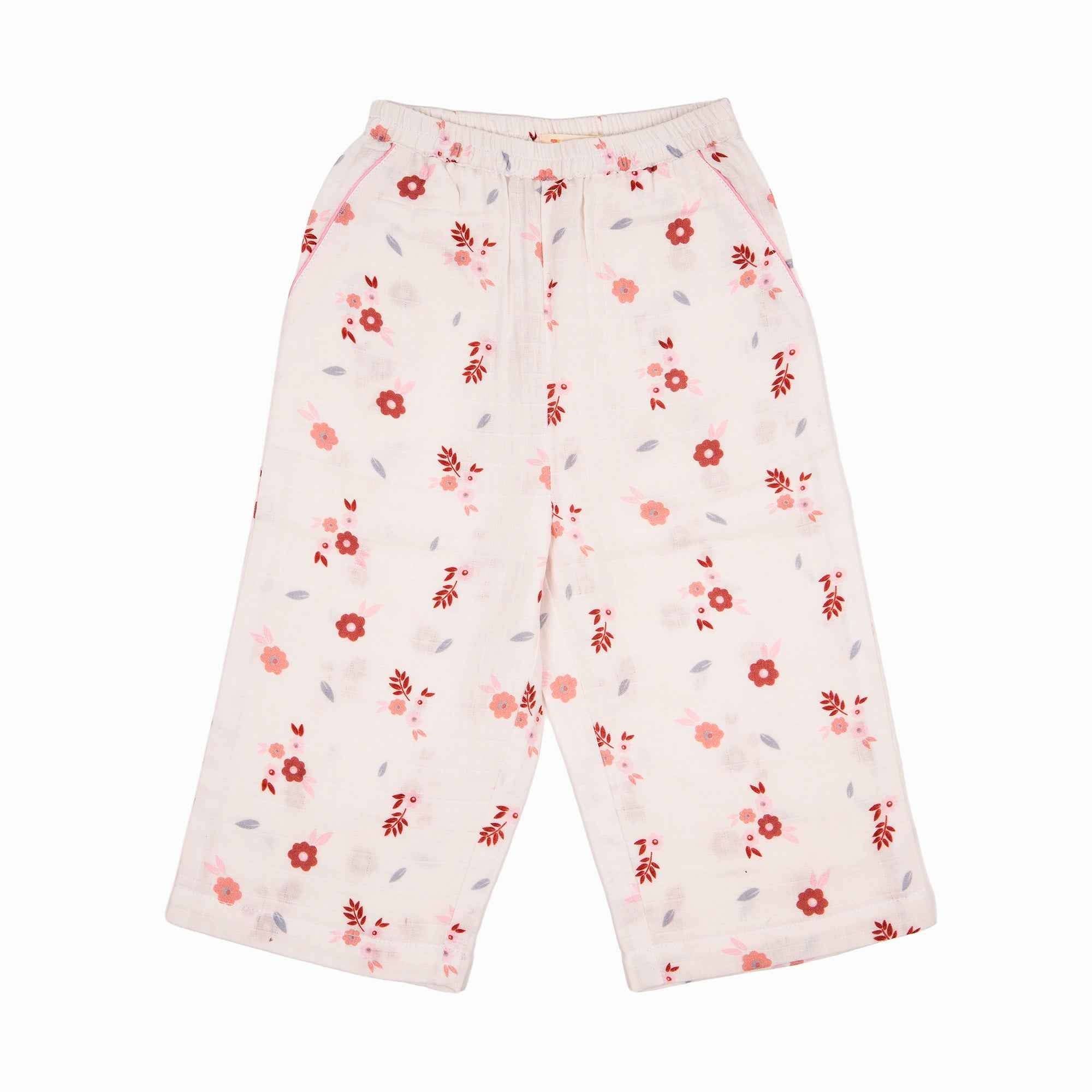 A set of baby's nightsuit with a pants featuring a red and pink floral pattern.