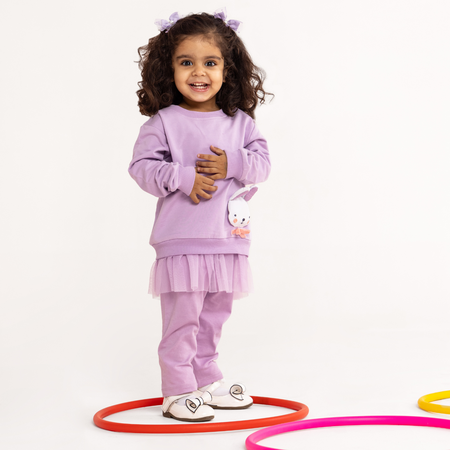 A baby girl wearing lavender color sweatshirt with slack set