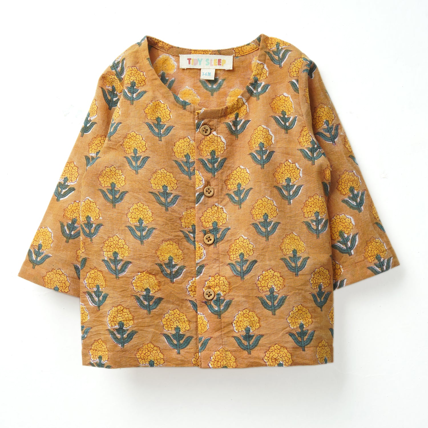 A mustard yellow button-up shirt with floral patterns and blue accents, featuring three-quarter sleeves and a rounded neckline.
