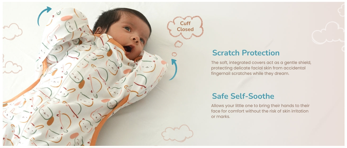 Baby wearing a printed outfit with closed cuffs for scratch protection and safe self-soothing by bringing hands to the face comfortably.