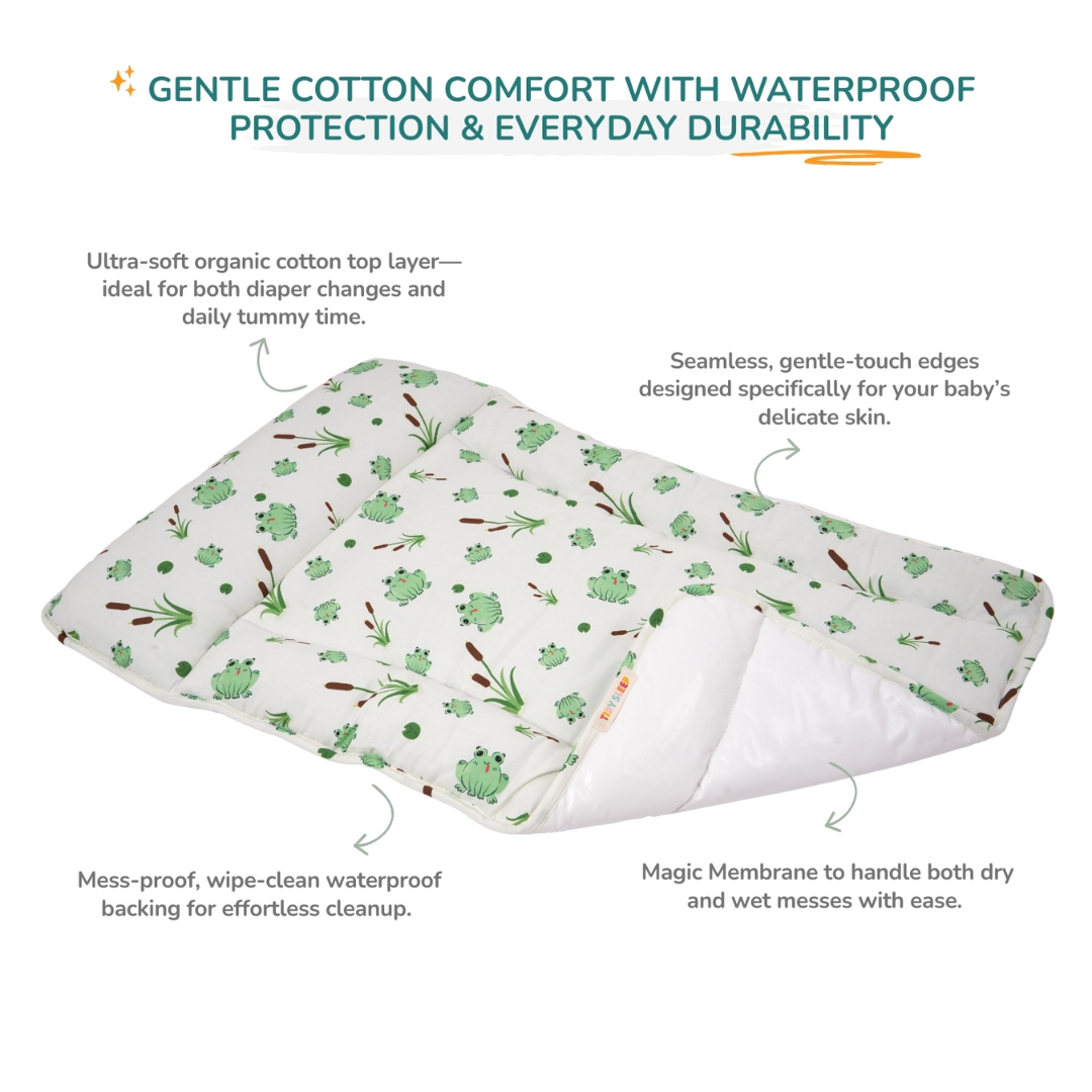 A baby changing station shown on a white background with marketing text and callout lines describing its soft cotton top layer, waterproof backing, and gentle edges.