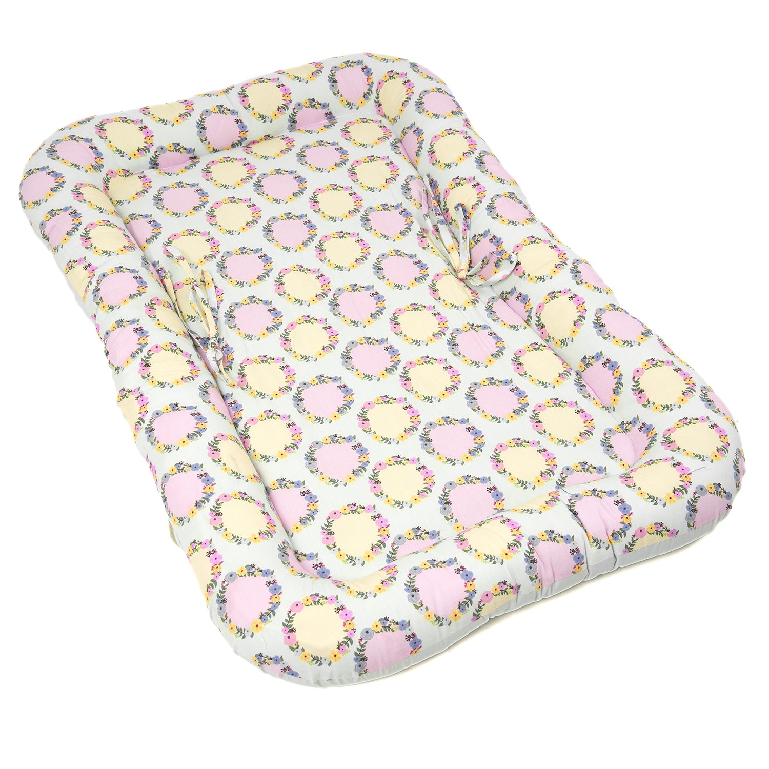 A padded baby gadda set featuring a floral pattern with pink and yellow accents, offering comfort for infants.