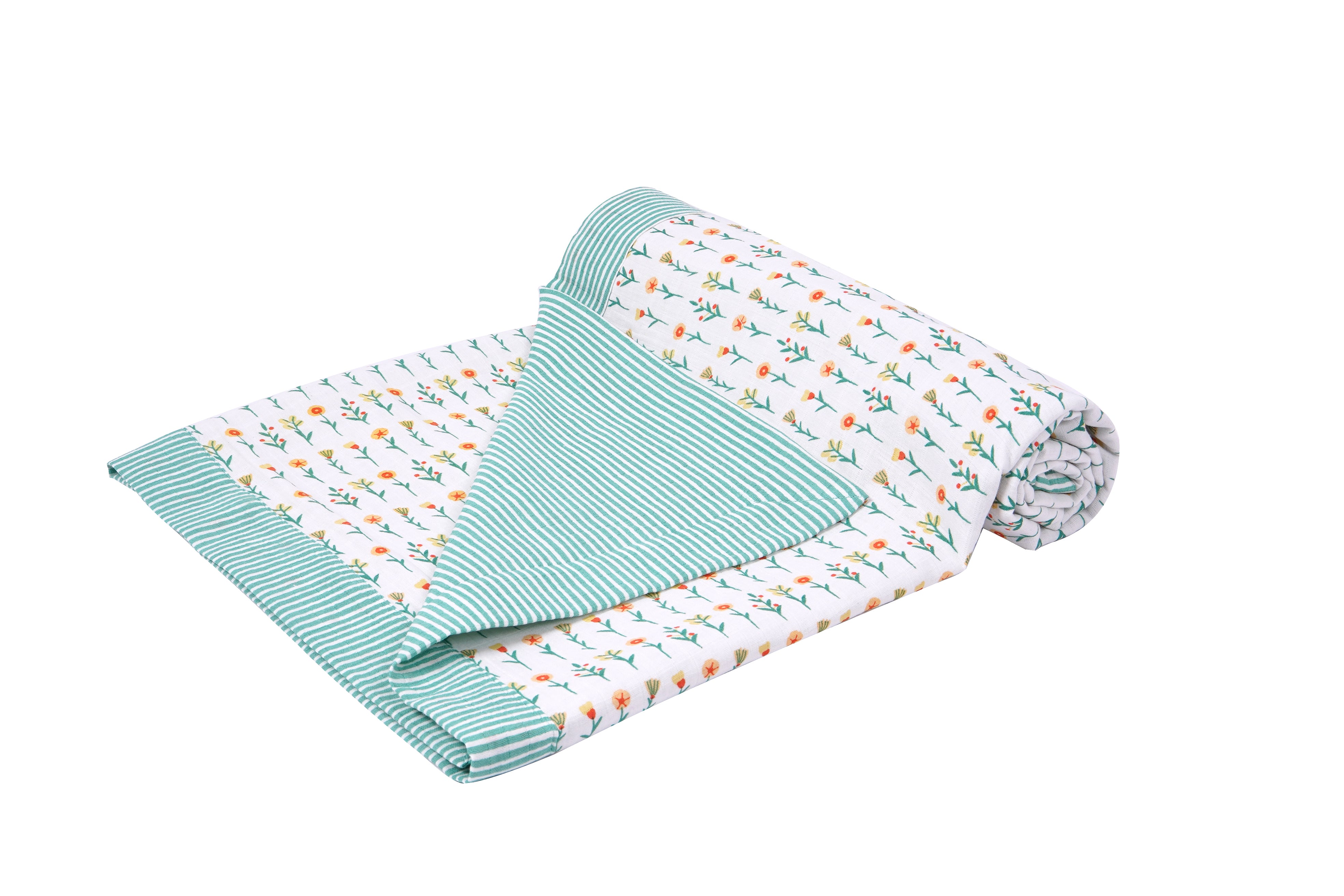 A rolled blanket featuring a floral pattern on one side and green striped fabric on the other, displaying a cozy design.