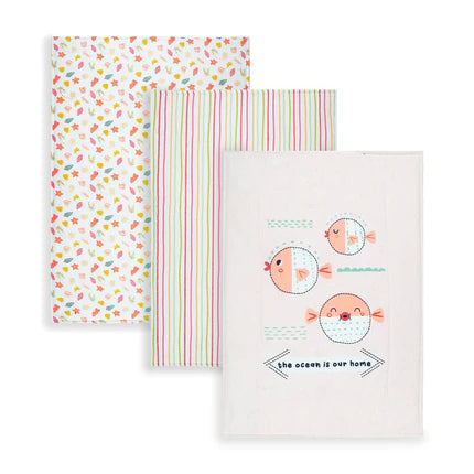 Three baby changing mats are shown. One has colorful leaves, another has vertical stripes, and the third features fish with "the ocean is our home" text. Bright and cheerful.