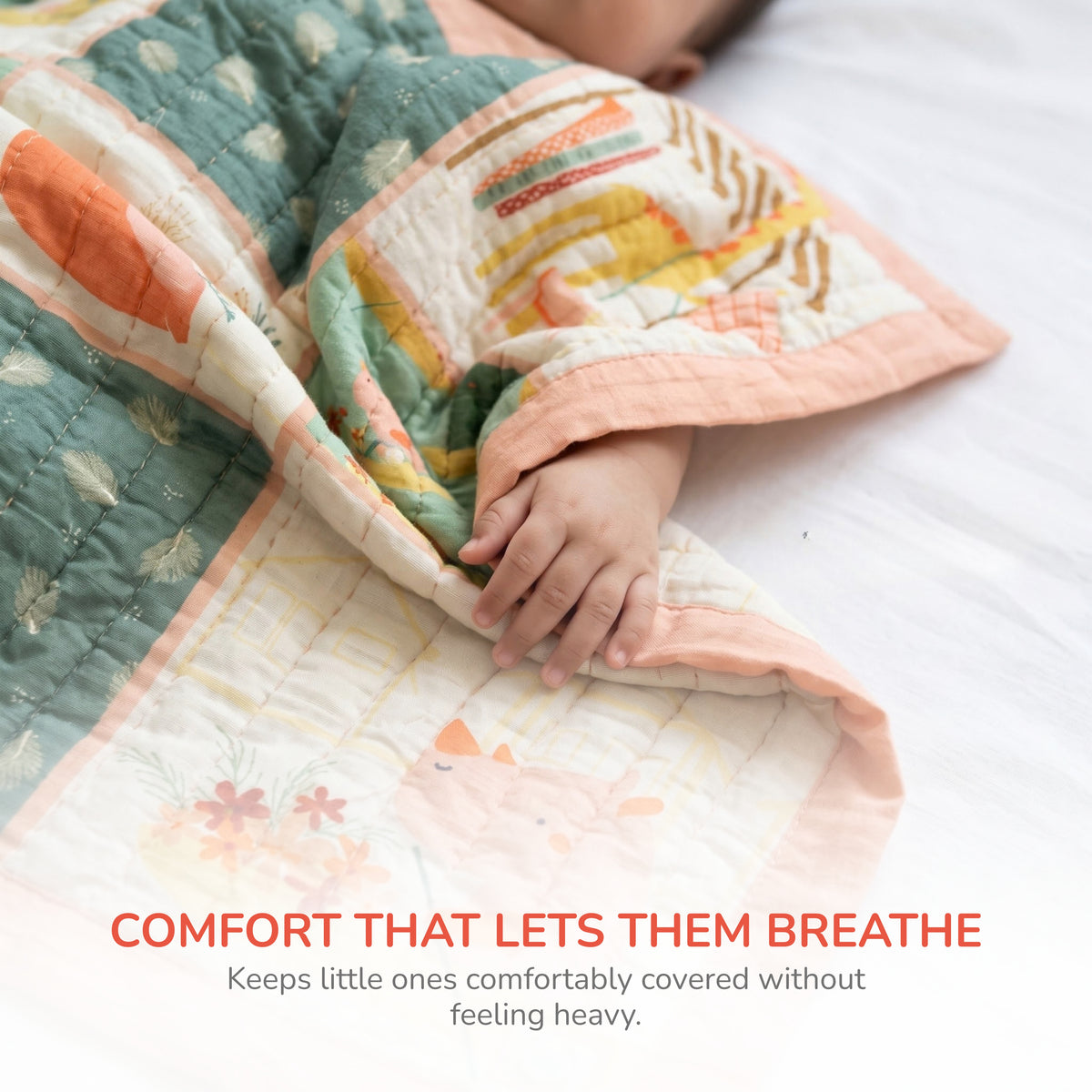 A baby wrapped in a soft quilted blanket with a pastel patchwork design, resting on a white bed. The blanket features a green floral pattern, peach borders, and orange, yellow, and white geometric accents.