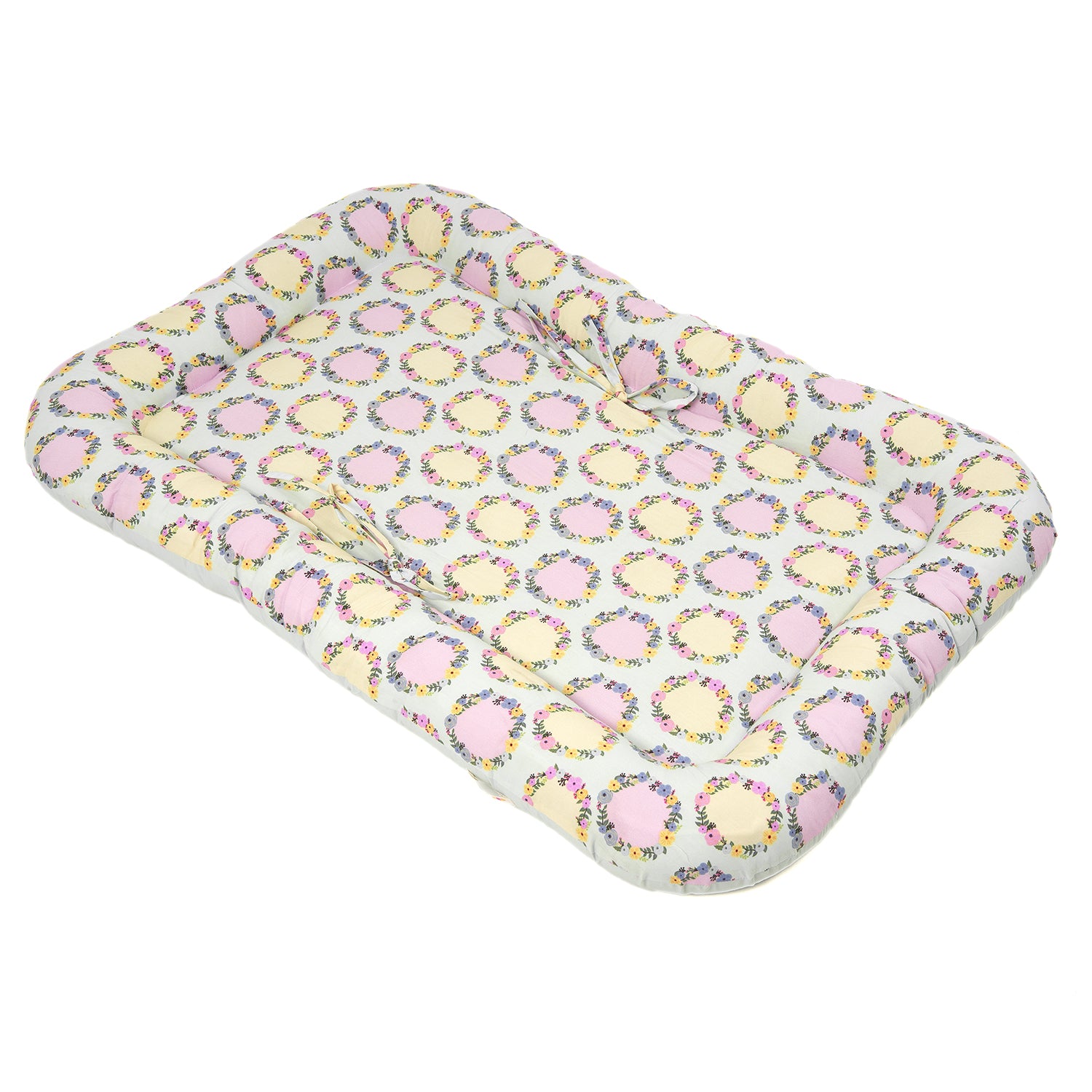 Tilted view of Aapadded baby gadda set featuring a floral pattern with pink and yellow accents, offering comfort for infants.
