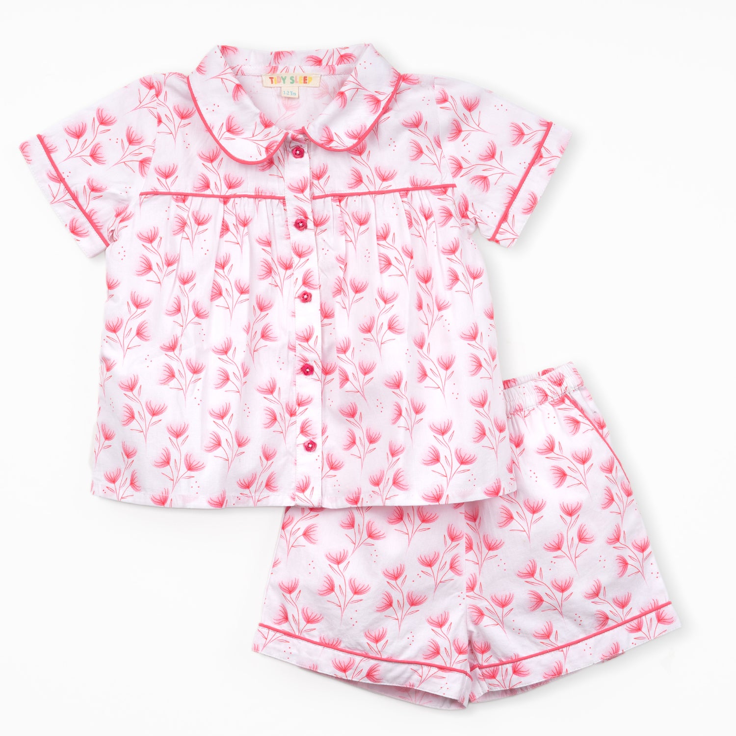 Cute pink and white floral baby pajama set featuring a collared short-sleeve top and matching shorts with an elastic waistband.